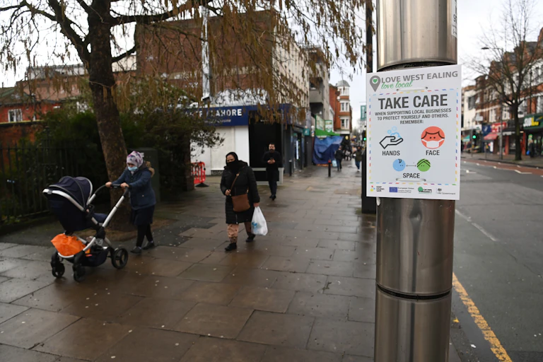 A government coronavirus notice is displayed in Ealing, London, warning people to 'Take Care'.
