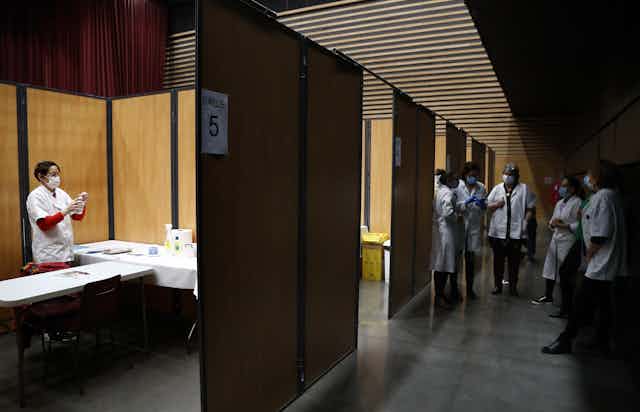 Medics in France prepare vaccines.