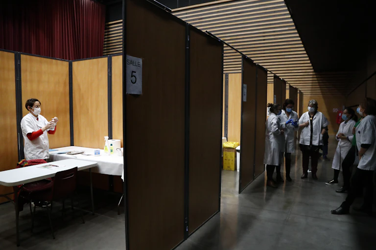 Medics in France prepare vaccines.