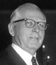 Headshot of a middle-aged white man wearing glasses.