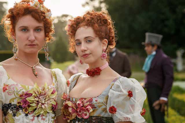Two women in period costumes.