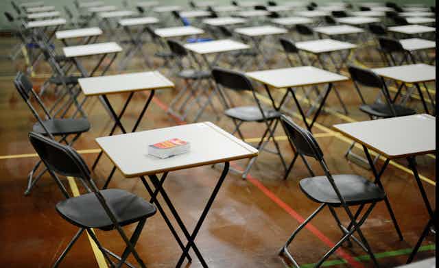 Empty chairs and desks in an exam hall. 