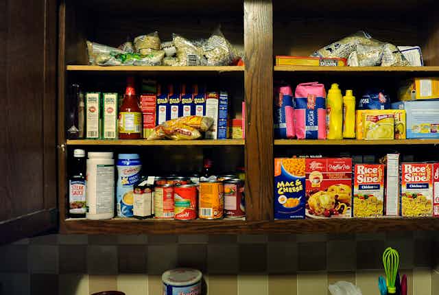 A cupboard stocked with dried beans and other affordable and nutritious food.
