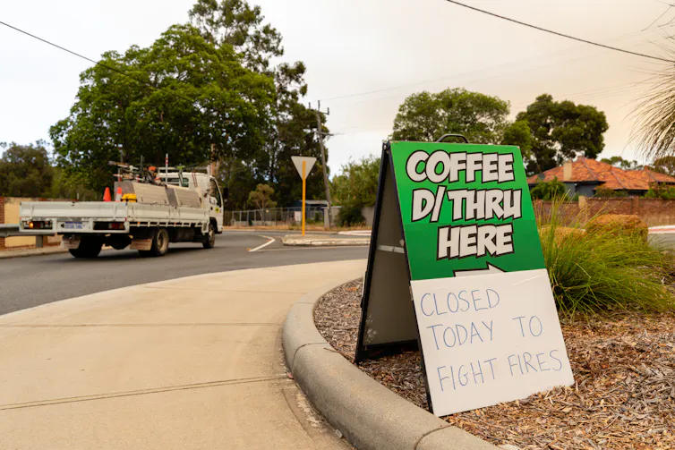 A drive-through coffee shop sign that reads 'closed today to fight fires'