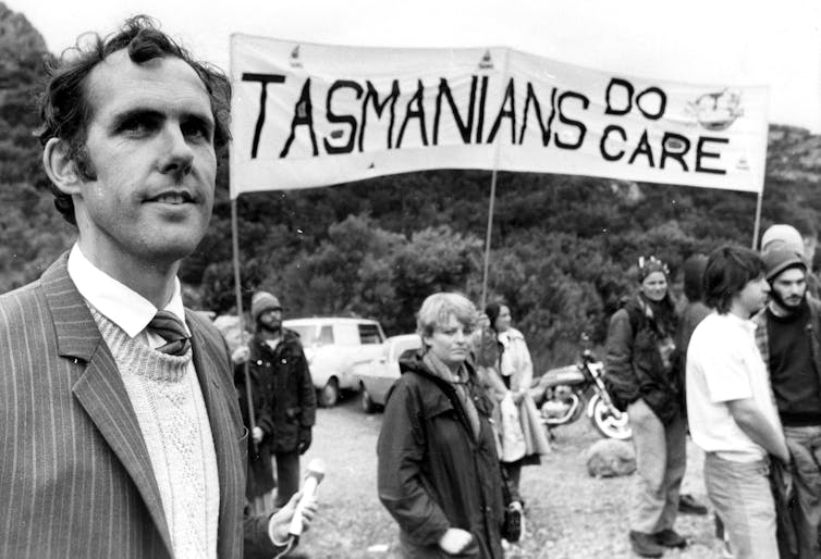 Young Bob Brown and other protesters, a banner reads 'Tasmanians do care'.