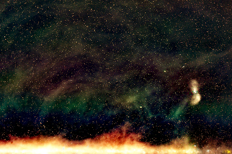 A "radio colour" view of part of the sky from the Galactic and Extragalactic All-sky MWA (GLEAM) survey. In the lower right corner is the large radio galaxy Centaurus A; most of the smaller dots in the image are similar galaxies further away.