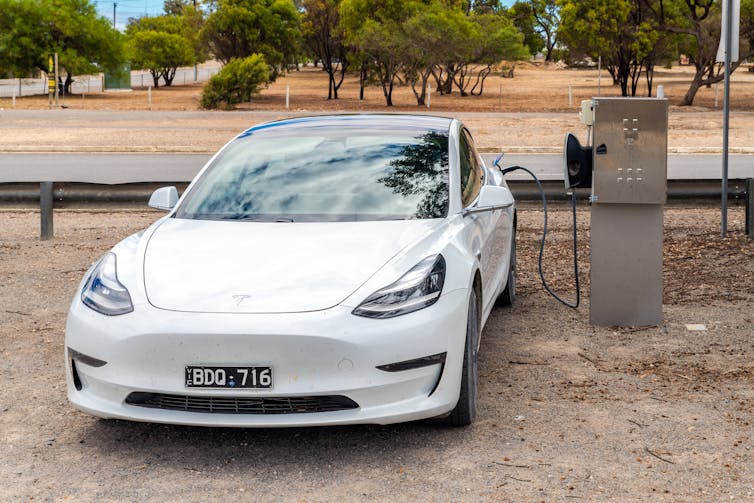 Tesla being charged at a rural charging point