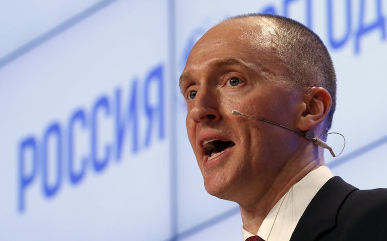 Head shot of Carter Page giving a speech with headset microphone.