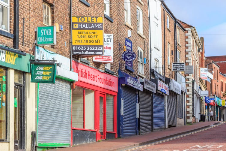 Closed storefronts and to let signs on high street