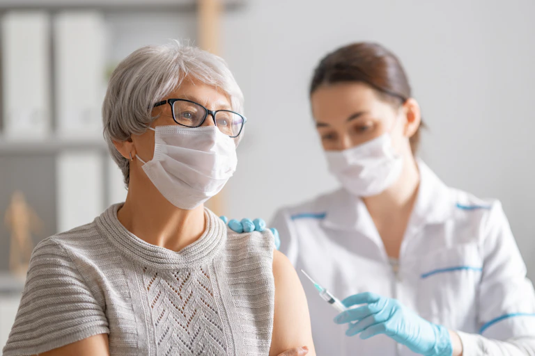 A nurse vaccinating a woman