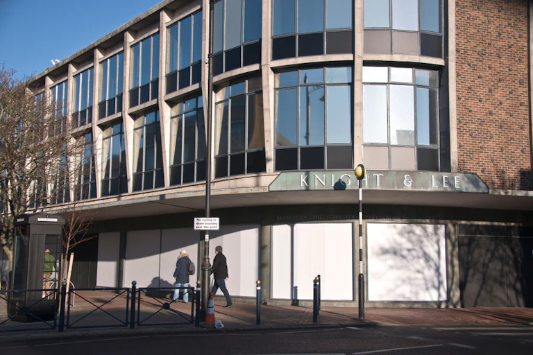 Closed department store, windows boarded
