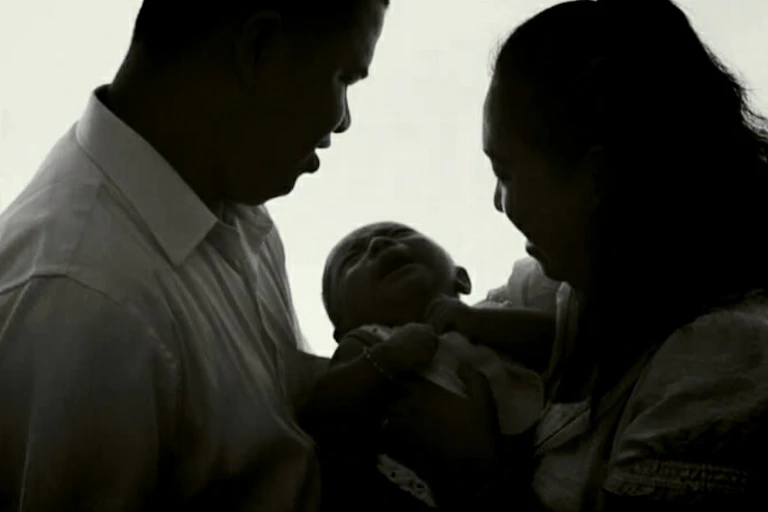 Man and woman holding a baby