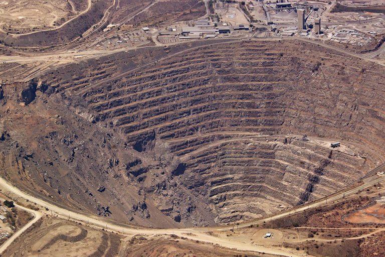 An aerial view of a massive hole in the earth.