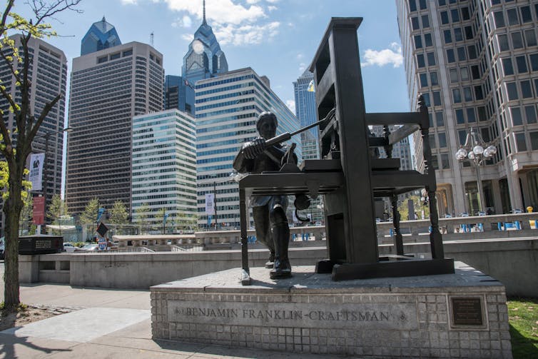 A statue of Franklin at his press, in the central part of Philadelphia, Pennsylvania.