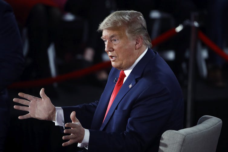 Donald Trump gestures during a public appearance