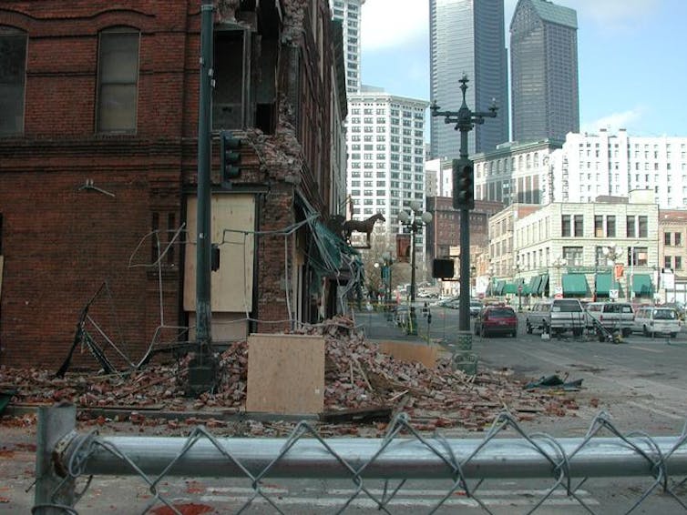 Rubble is seen in front of a damaged building.
