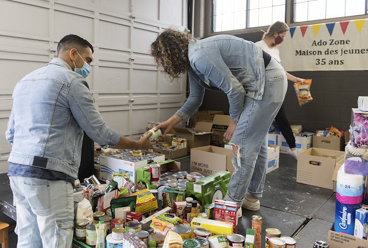 Volunteers sort through donated food items.