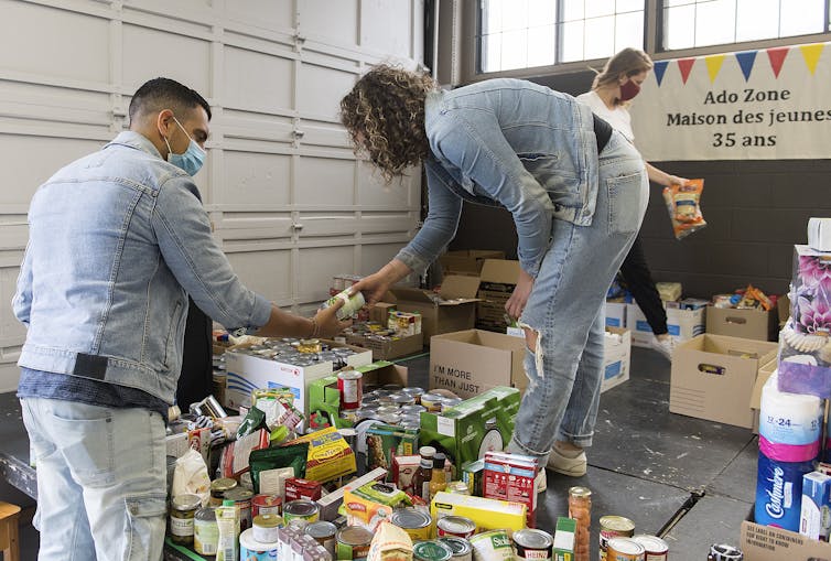 Volunteers sort through donated food items.