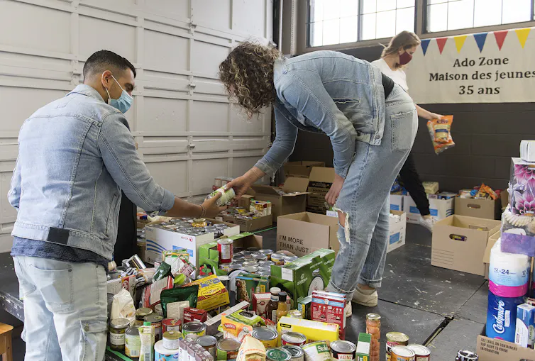 Volunteers sort through donated food items.