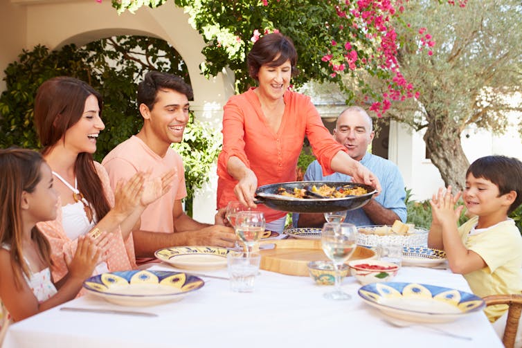 A migrant family at the table, eating lunch.