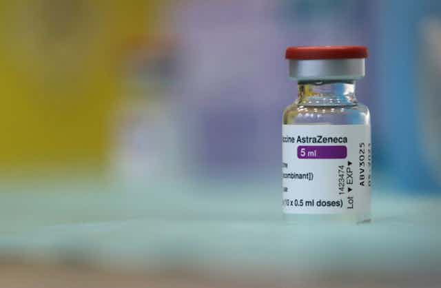 A vial of the AstraZeneca vaccine sits on a table.