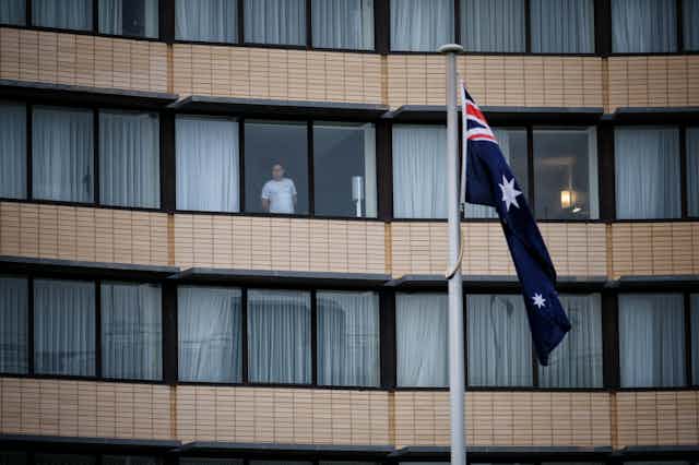 A guest is seen through the window at the Holiday Inn hotel at Melbourne Airport.