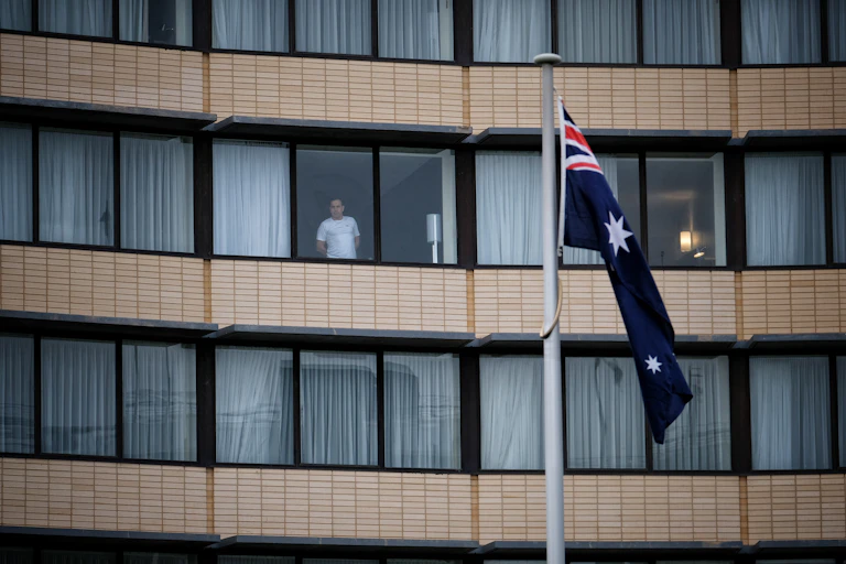 A guest is seen through the window at the Holiday Inn hotel at Melbourne Airport.