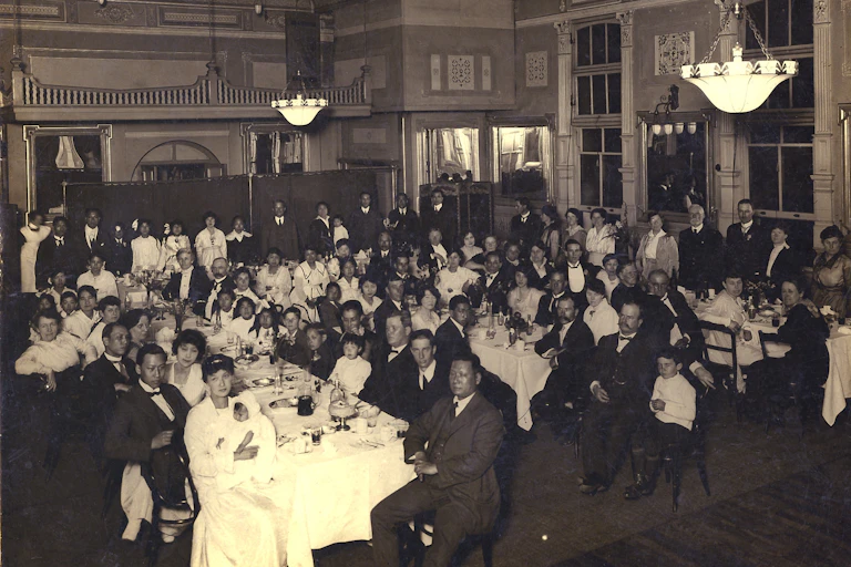 Crowd of men and women at a dinner.