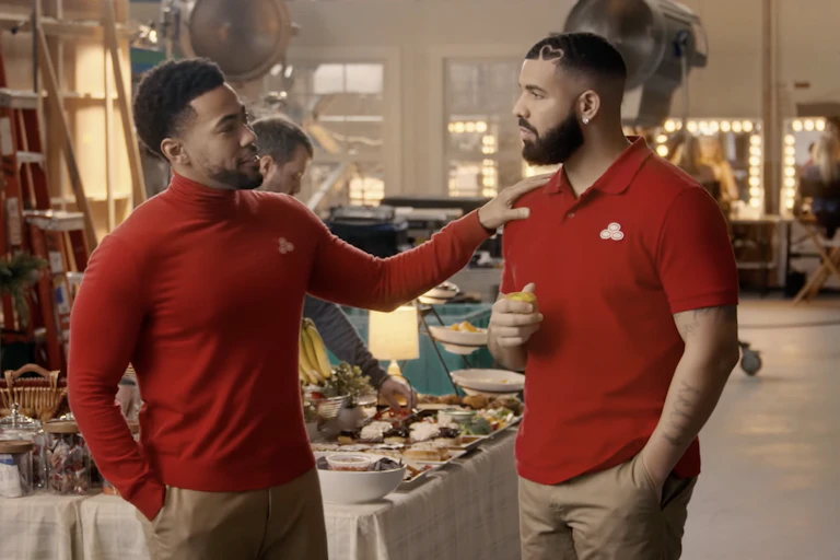 A man puts his hand on another man's shoulder.