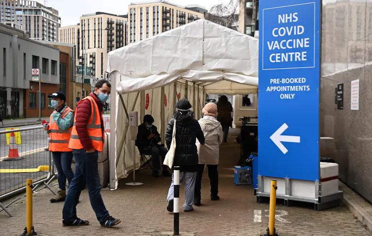People queuing for vaccinations in London.