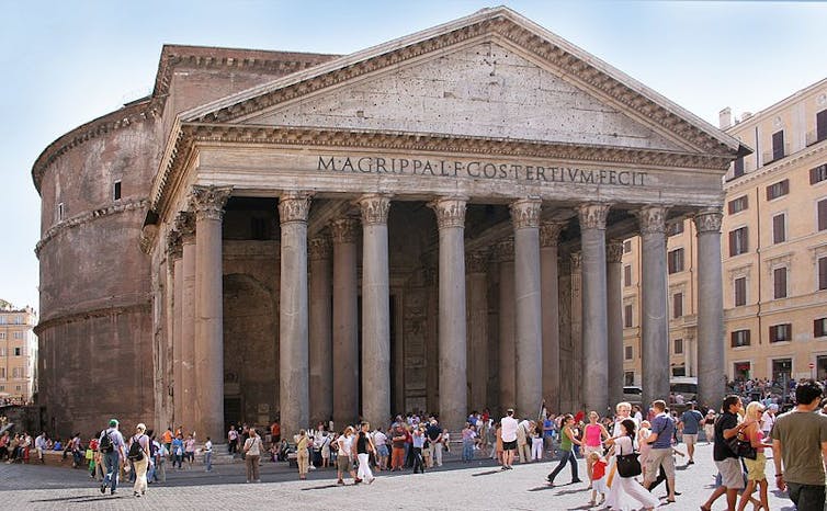 The Pantheon, n ancient building with columns and a dome, and a crowd in front of it