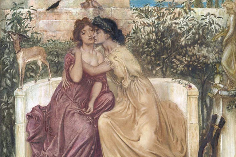 Two women embrace.