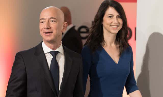 Jeff Bezos stands next to his ex-wife, MacKenzie Scott.and a tall woman.