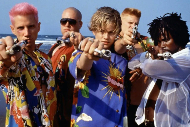 Romeo and his gang wear bright shirts and point their guns.