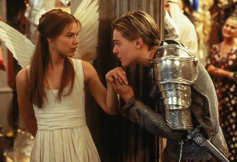 Juliet as an angel, Romeo as a knight. He goes to kiss her hand.