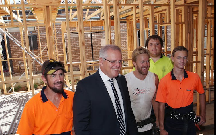 Prime Minister Scott Morrison and tradesmen on a home construction site