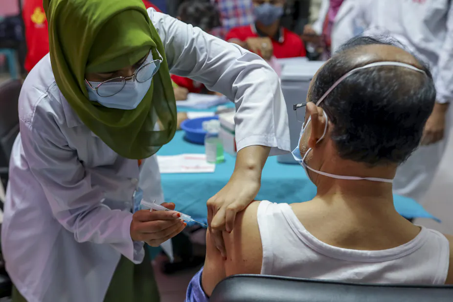 Nurse injecting patient