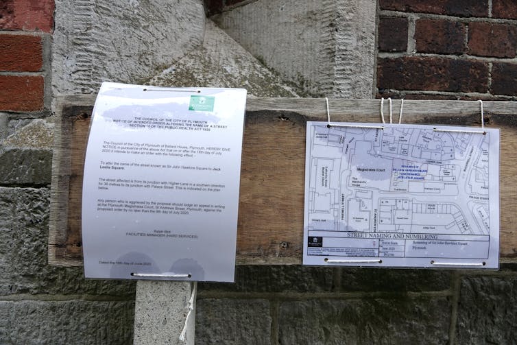 Two signs pinned to a street sign informing the public that the council plans to rename Sir John Hawkins Square.
