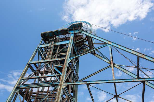 The rusty winding gear of a disused colliery.