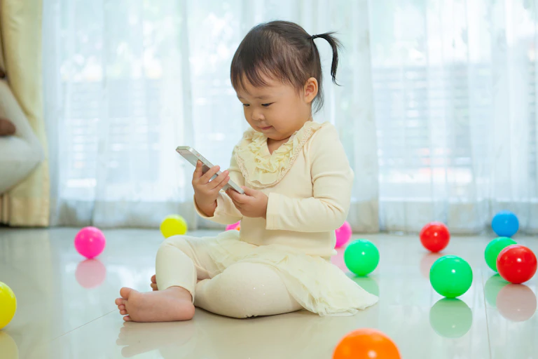 Toddler looking at mobile phone