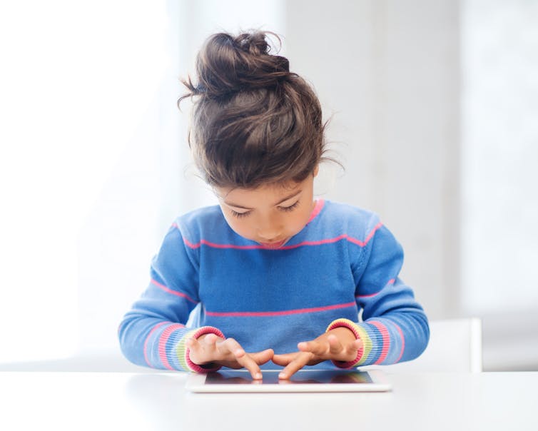 Small girl using a touchscreen tablet