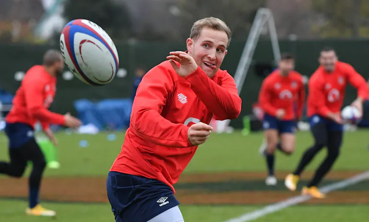 An England rugby players passes the ball during a training session, November 2020.