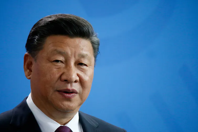 Xi Jinping against a blue background