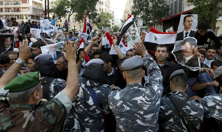 Soldiers surround a group of Syrian protesters in Beirut, Lenanon, March 2011.