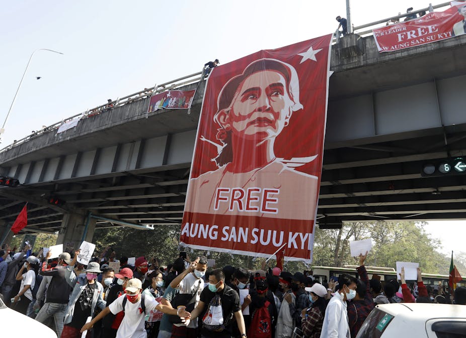Banner saying 'Free Aung San Suu Kyi' hanging from a road bridge