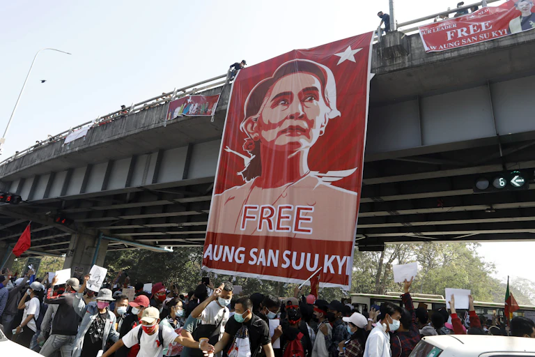 Banner saying 'Free Aung San Suu Kyi' hanging from a road bridge