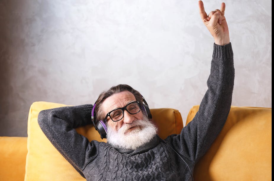 Image of senior man listening his favorite rock music song, modern technology