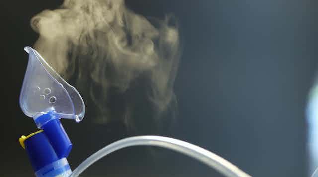 Nebuliser mask showing aerosols of medicine