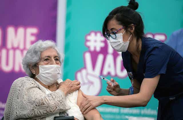 A nurse vaccinating a woman in Chile