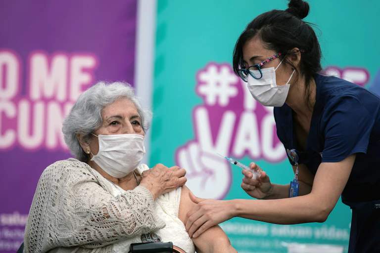 A nurse vaccinating a woman in Chile